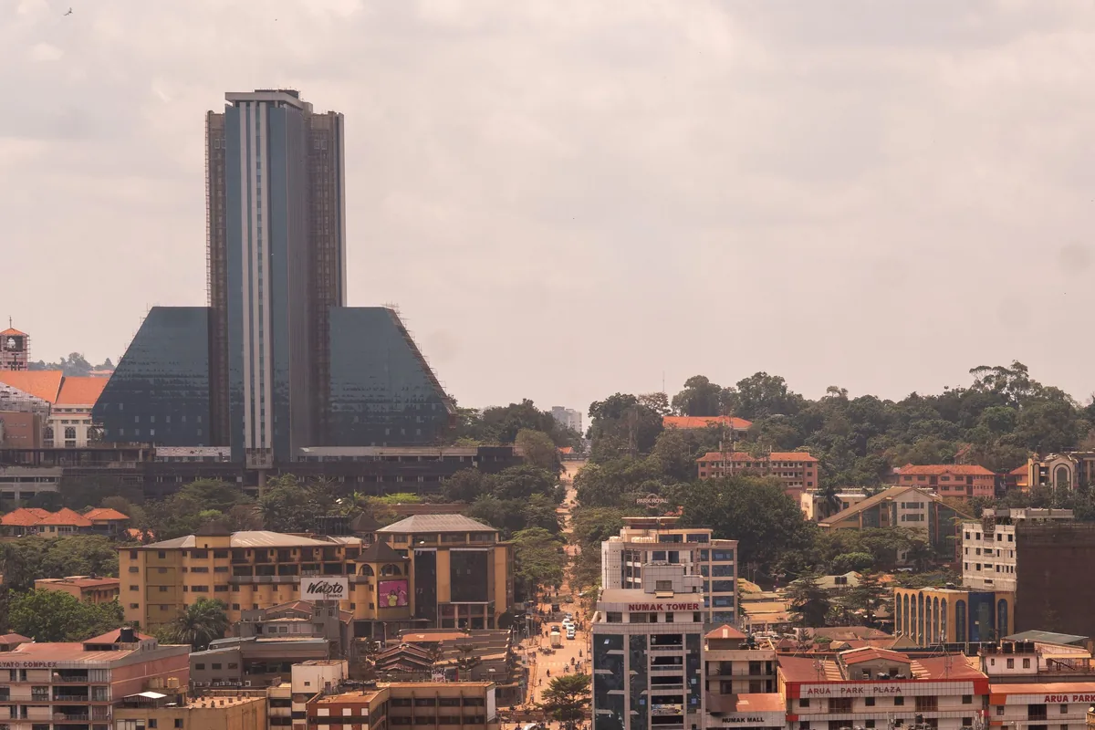 Aerial view of central Kampala with a tall office tower above the rooftops
