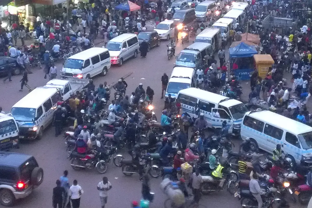 Evening rush hour in Nakivubo, central Kampala, with crowds, minibuses and boda bodas